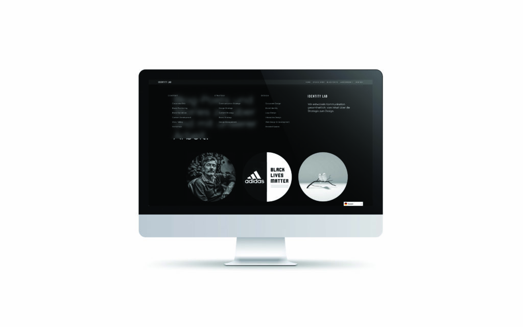 Auf einem Computermonitor wird eine Website mit dunklem Thema angezeigt, mit Menüs im oberen Bereich und kreisförmigen Bildern im unteren Bereich, darunter eine Statue, ein Adidas-Logo, ein Black Lives Matter-Text und ein abstraktes Objekt.