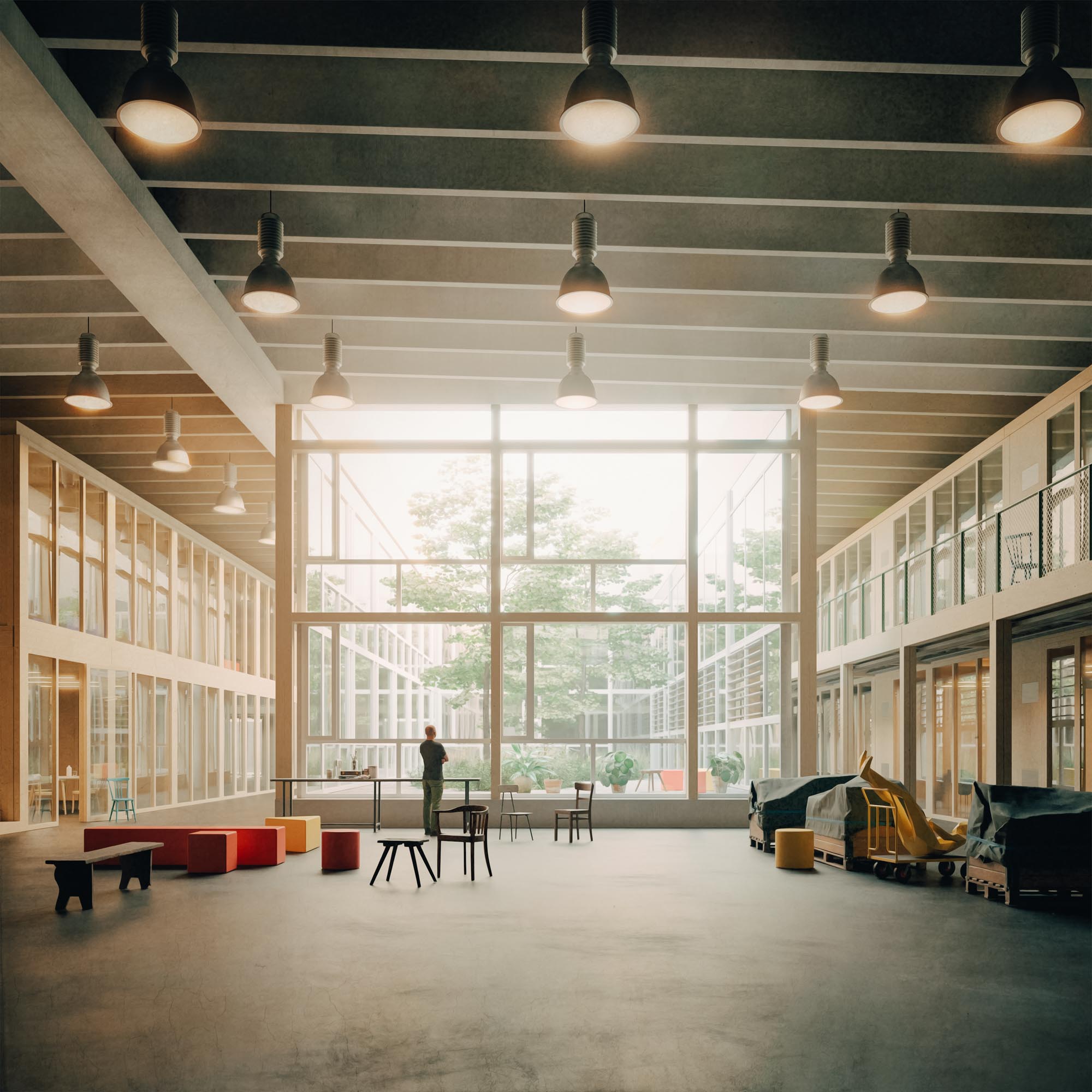 A spacious, modern atrium with large windows, plenty of natural light, minimal furniture and one person at a table. Children's play equipment and benches suggest a multi-purpose communal area - ideal for hosting a Creative Transformation Summit.