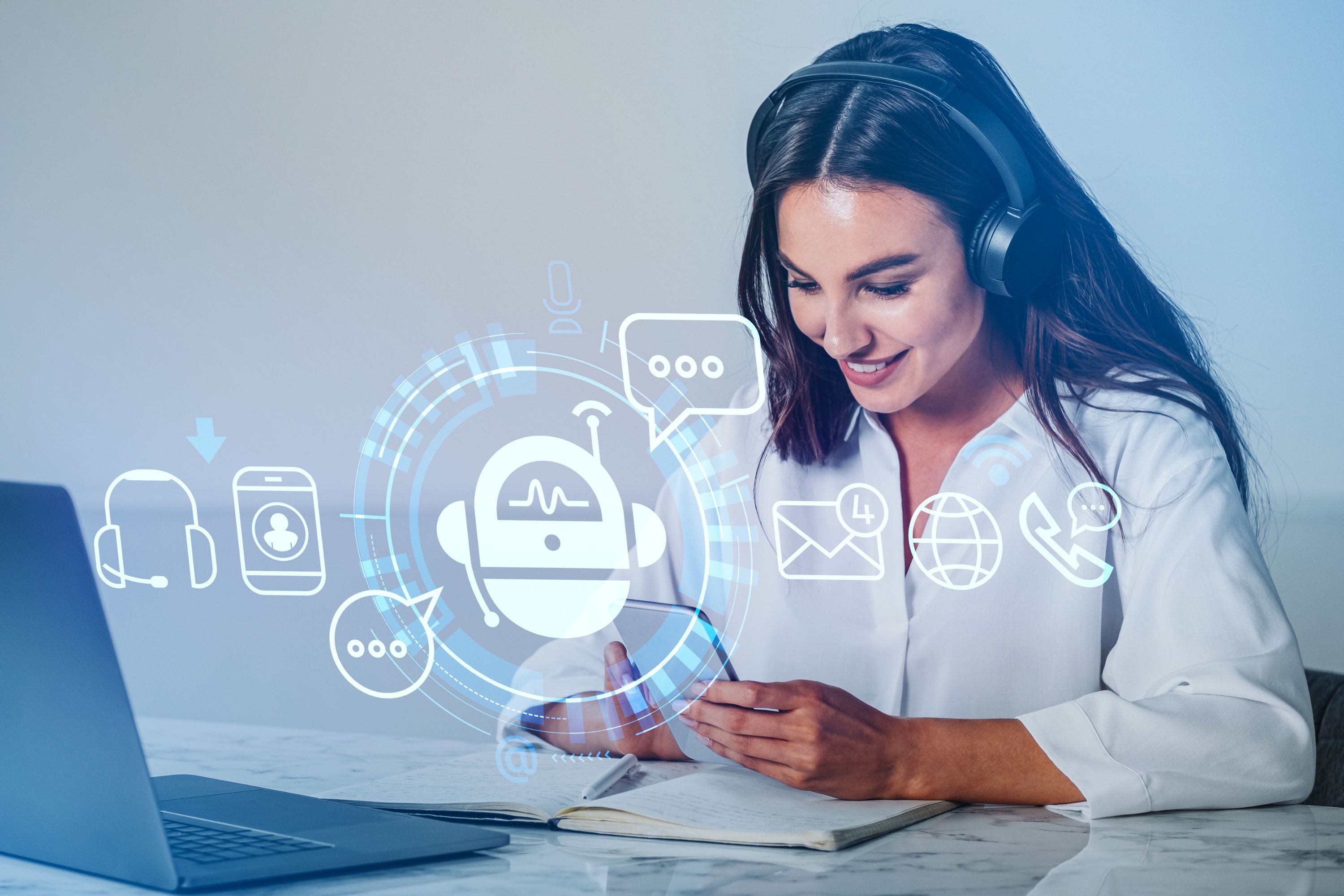 A woman with headphones sits at a desk with a laptop, smiling and looking at her phone. Digital symbols of a chatbot, messages, e-mail, globe and telephone are superimposed and symbolize AI and digital communication.