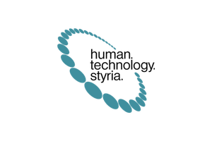 Logo mit tealfarbenen ovalen Formen, die ein kreisförmiges Muster um den schwarzen Text human. technology. styria. auf einem hellgrauen Hintergrund bilden, der den kreativen Wandel im Bereich Gesundheitstechnologie und soziale Innovation widerspiegelt.