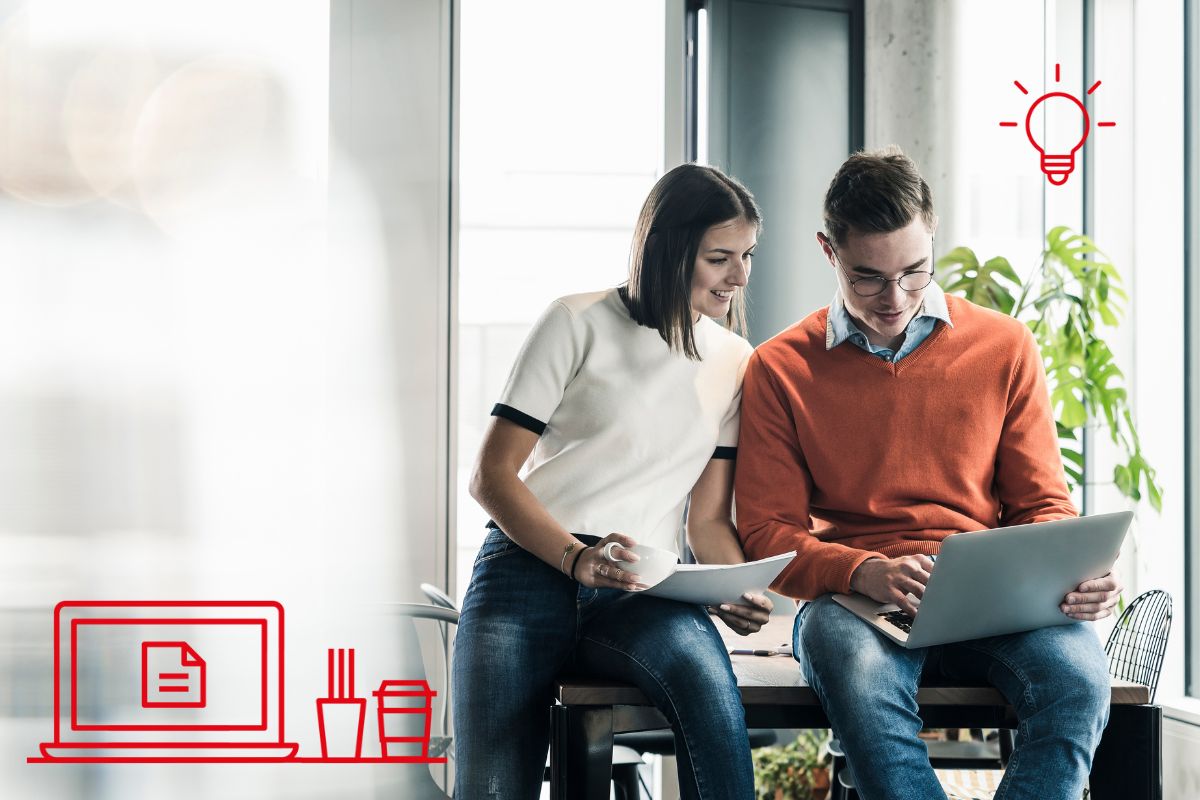 Two people sit together at a desk, looking at a laptop and holding papers. Red line symbols overlay the scene, suggesting creative brainstorming in a bold community focused on innovation and collaboration.